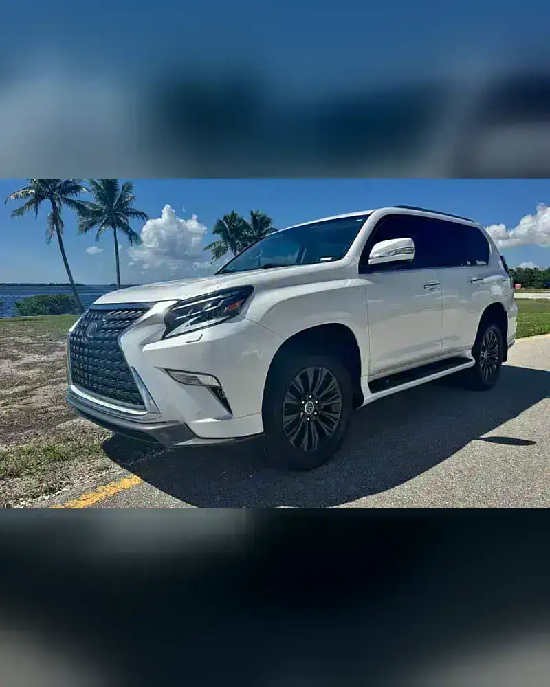 A 2021 Lexus GX from the SWFL Auto Rentals fleet, parked on a palm-lined coastal road
