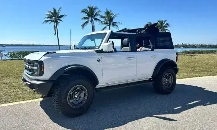 2024 Ford Bronco rental vehicle in white, top off, Southwest Florida coastline